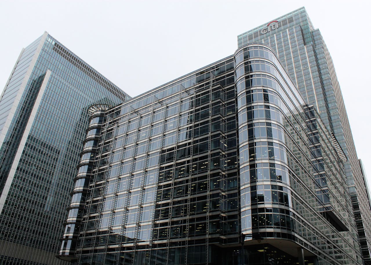 Low angle view of modern glass skyscrapers in an urban setting.